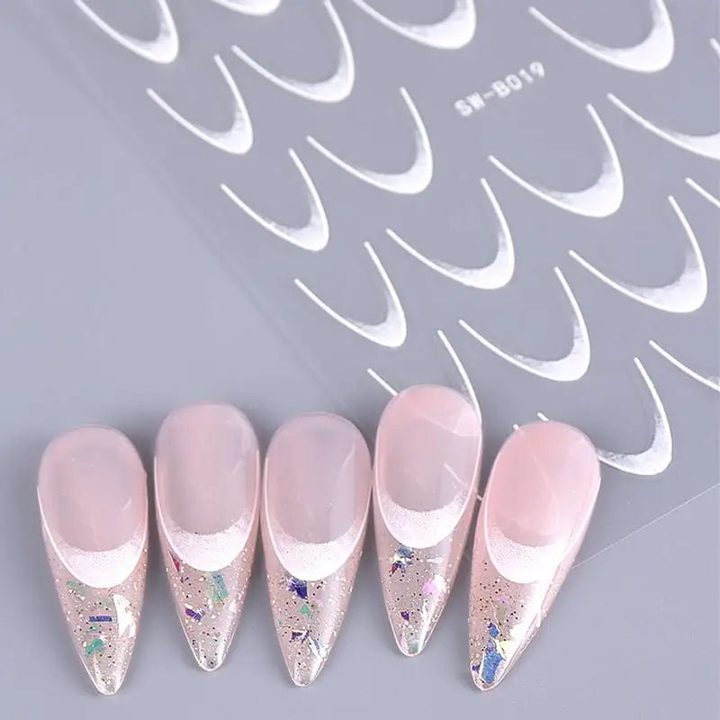 Paola Center nail art supplies including pink stiletto nails with glitter and nail art tips sheet