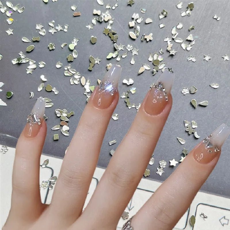 DIY luxury nail accessories set showing long nails decorated with silver glitter and rhinestones