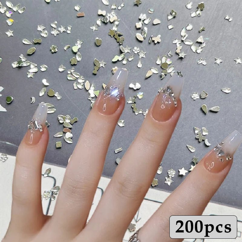 Hand with nails decorated using shiny silver pieces from a DIY luxury nail accessories set with 200 pieces