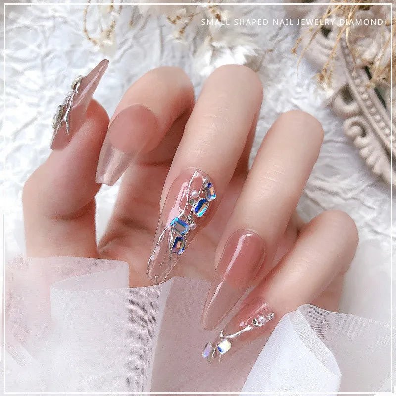 Elegant nails decorated with crystals from a DIY luxury nail accessories set by Paola Center