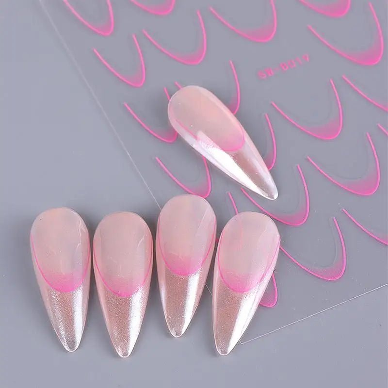 Pink and white fake nails with nail art supplies for stylish nail designs